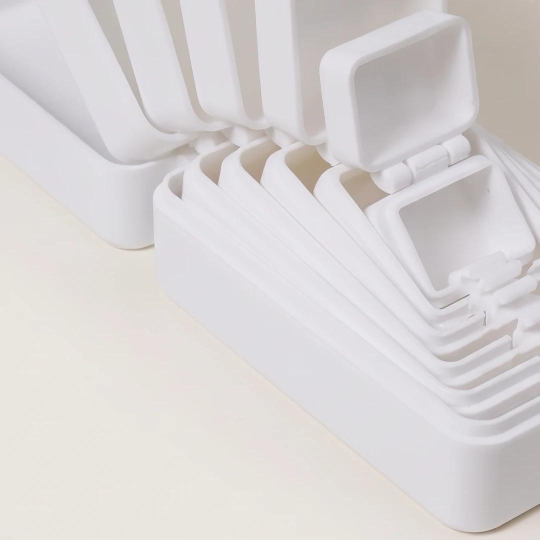 Close detail of the open White nesting lids and hinges